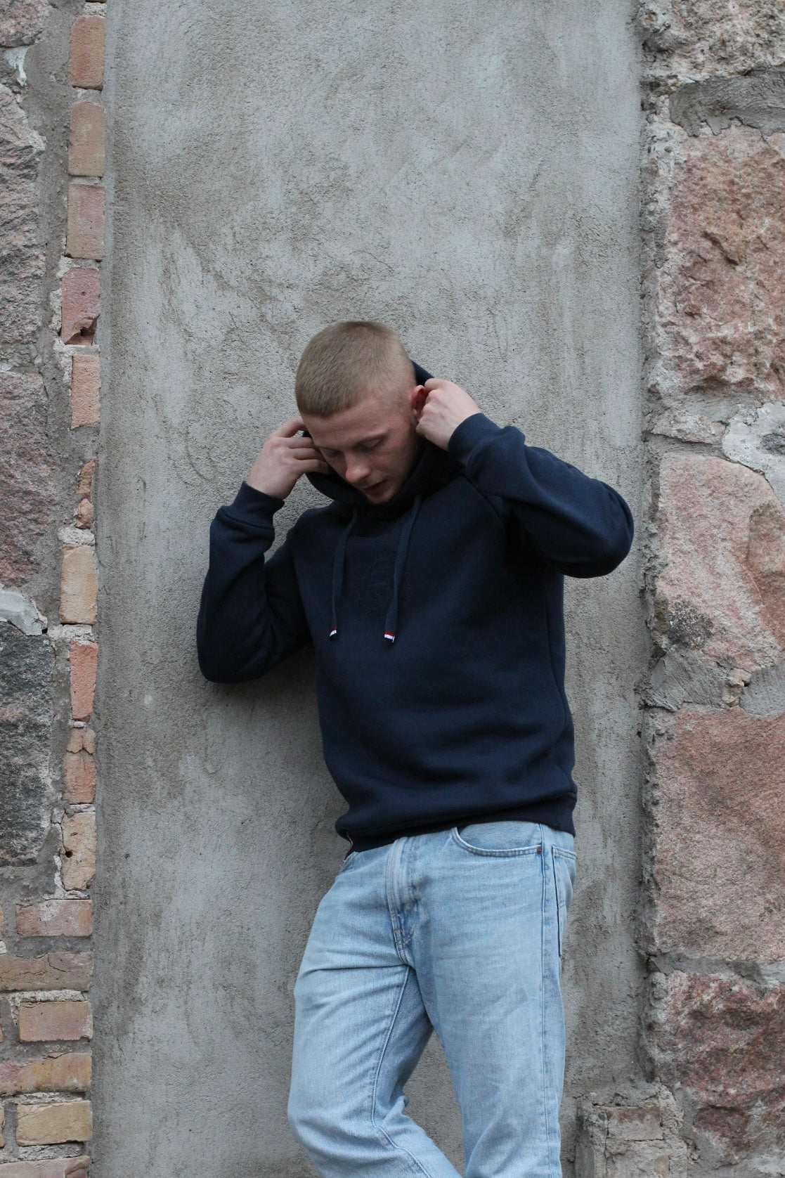 A regular sized Navy hoodie, Regular fit, Super Soft, Badge on left sleeve