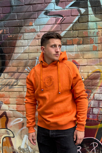 A regular sized Orange hoodie, Regular fit, Super Soft, Badge on left sleeve