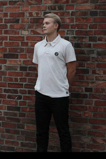 A regular-sized White Sand Terry Poloshirt, relaxed fit, super soft, with an ACE logo on the chest.